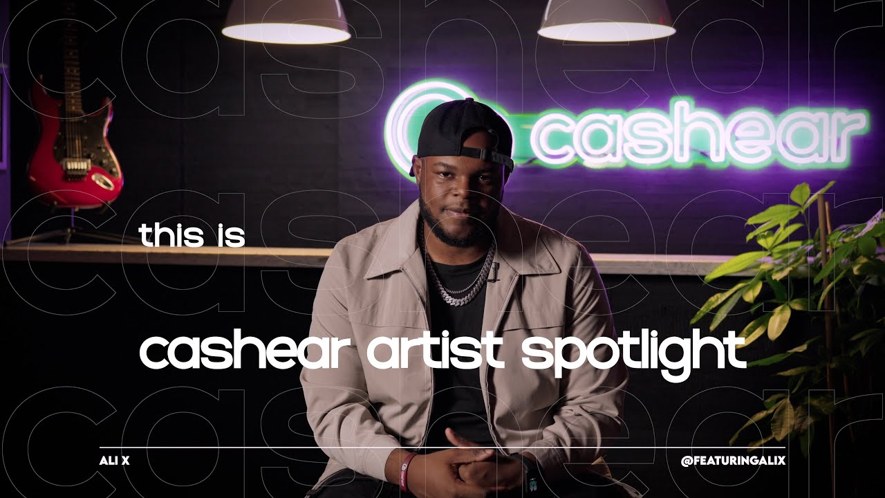 Ali X in a backwards cap and cream jacket over a chain on the Artist Spotlight set