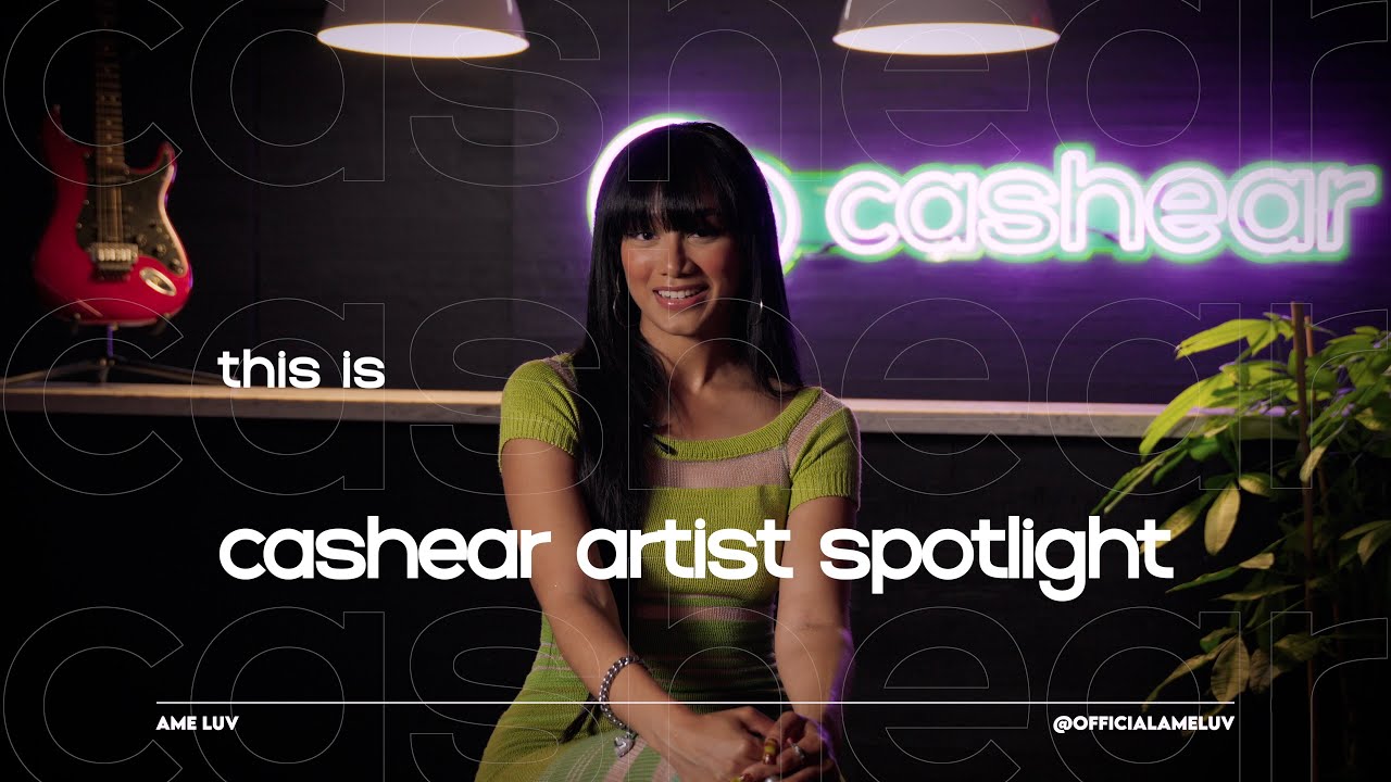 Ame Luv smiling in a lime green knit dress on the Artist Spotlight set