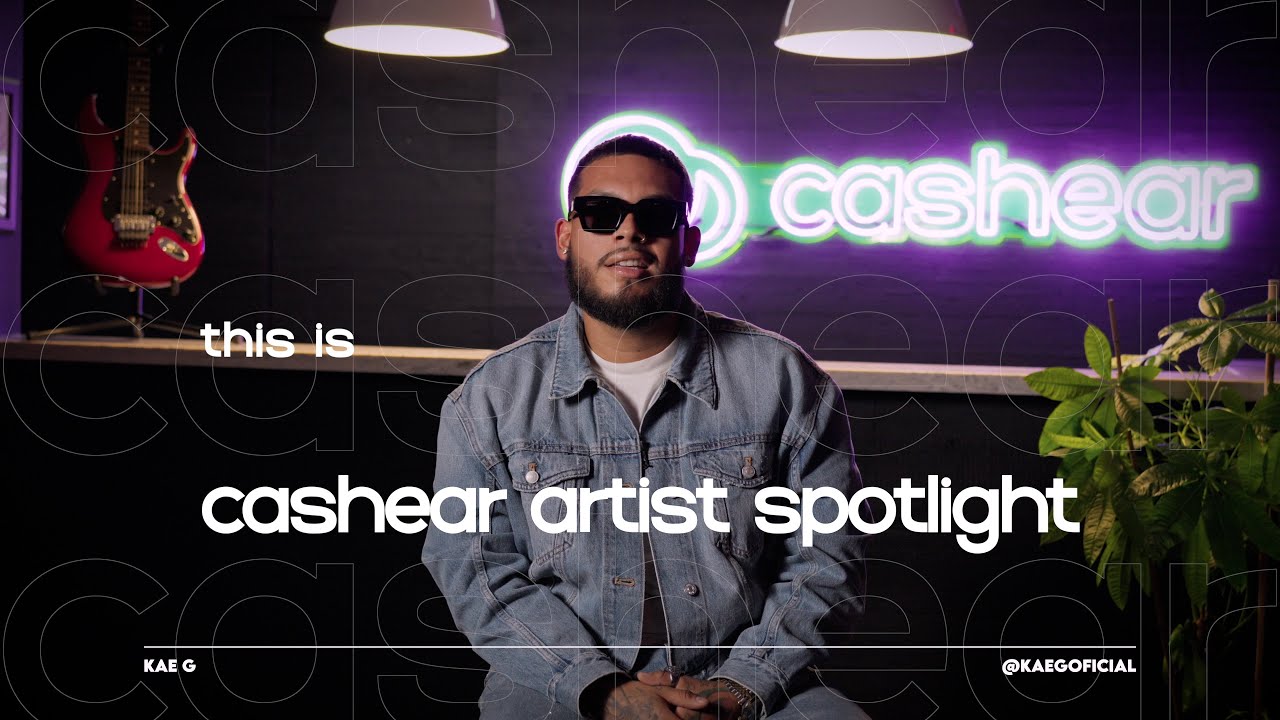 Kae G in sunglasses and a light denim jacket on the Artist Spotlight set