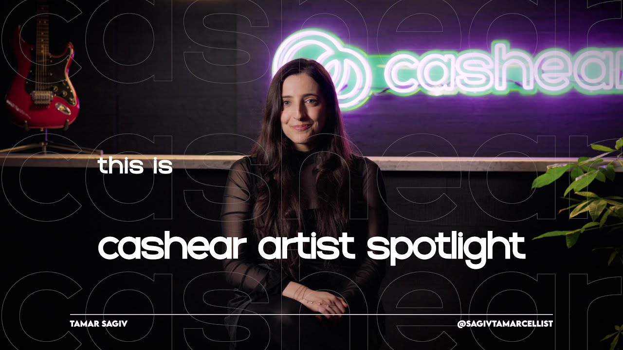 Tamar Sagiv in sheer black sleeves on the Artist Spotlight set, long dark hair over one shoulder