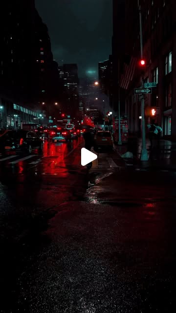 A rain slicked Manhattan street at night, red traffic signals reflecting on the wet asphalt