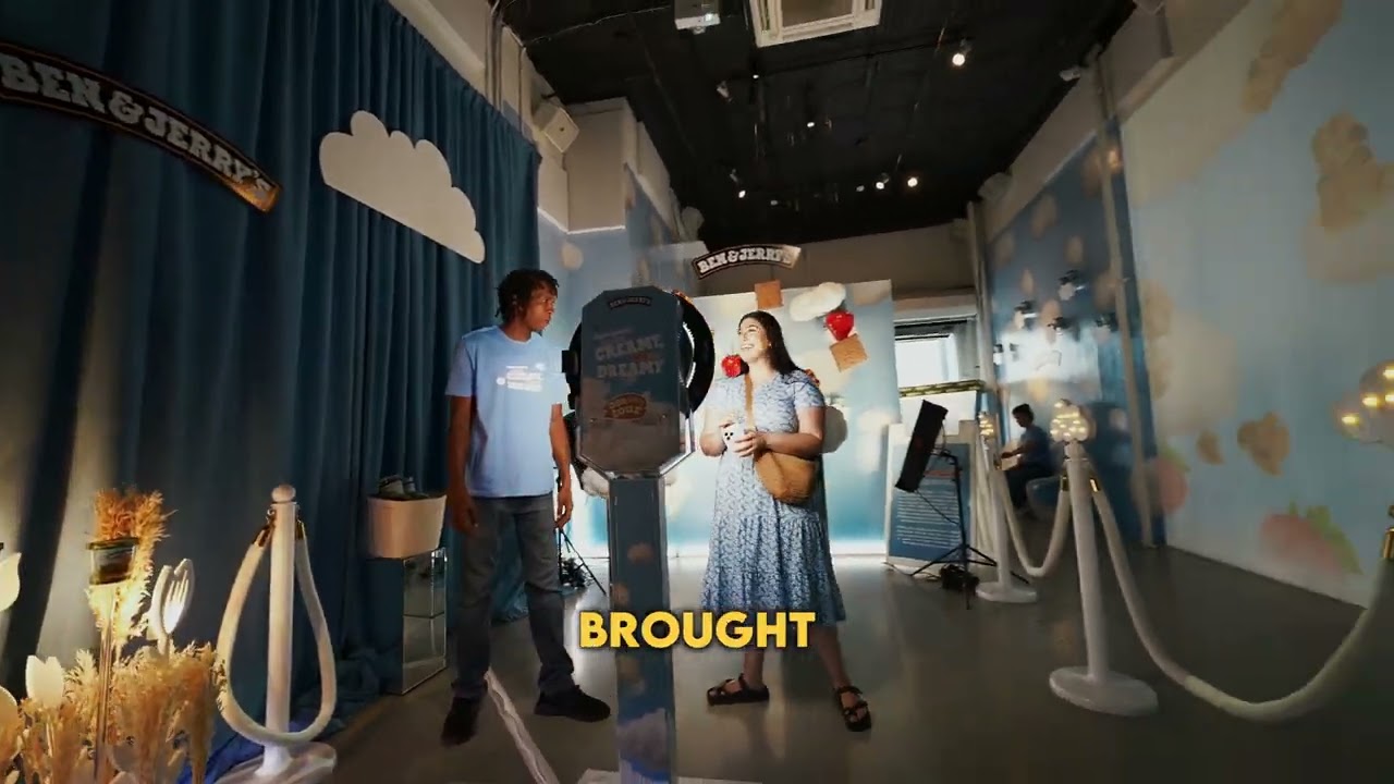 Guests at a photo booth inside the cloud themed Ben & Jerry’s Non-Dairy tour build at Lume Studios
