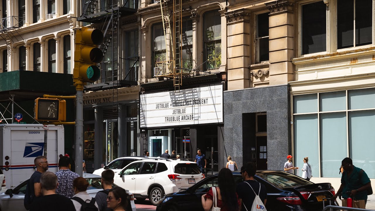 A theater marquee on a Tribeca street reads JetBlue and Thrillist present the JetBlue TrueBlue Arcade