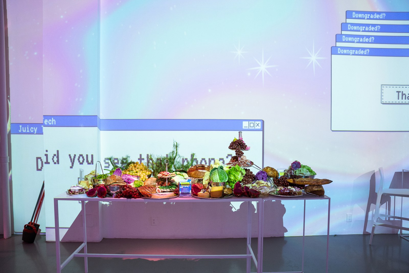 Long table of fruit and vegetables beneath projected chat windows and the words Did you see that phone