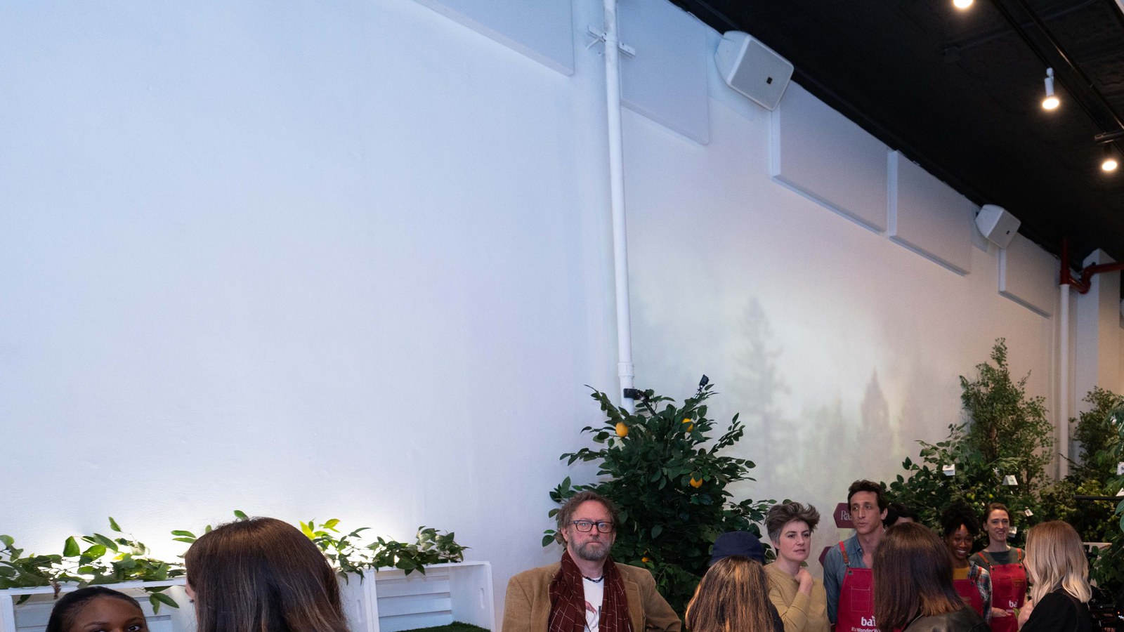 Fans photograph Sydney Sweeney at the raspberry lemon lime grove wall of Bai bottles