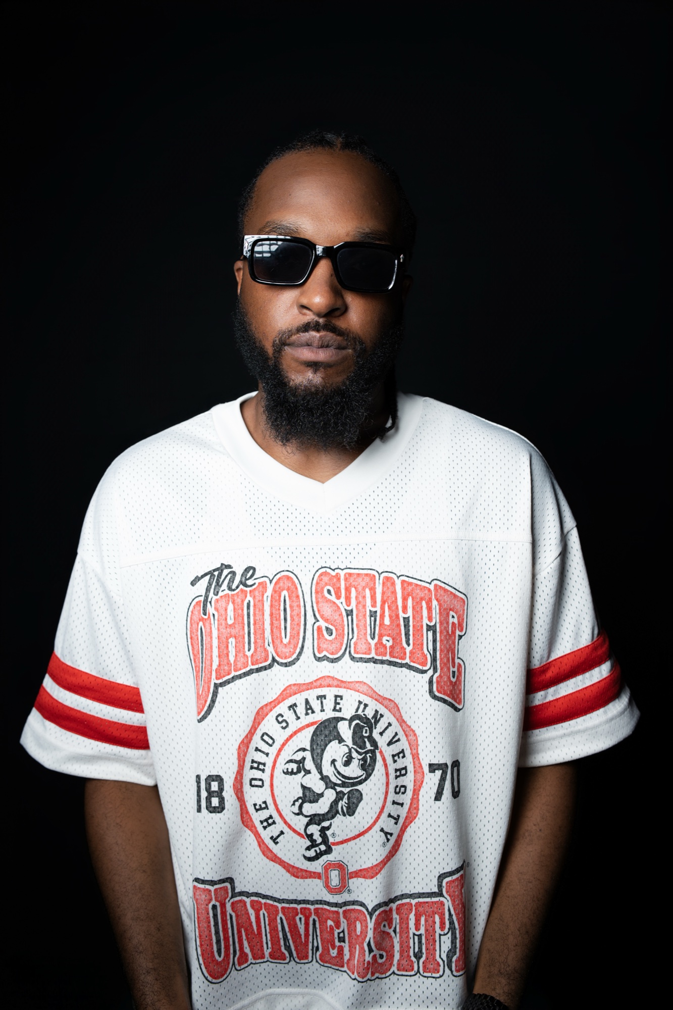 Judah Jah in a white Ohio State jersey and black sunglasses, facing the camera