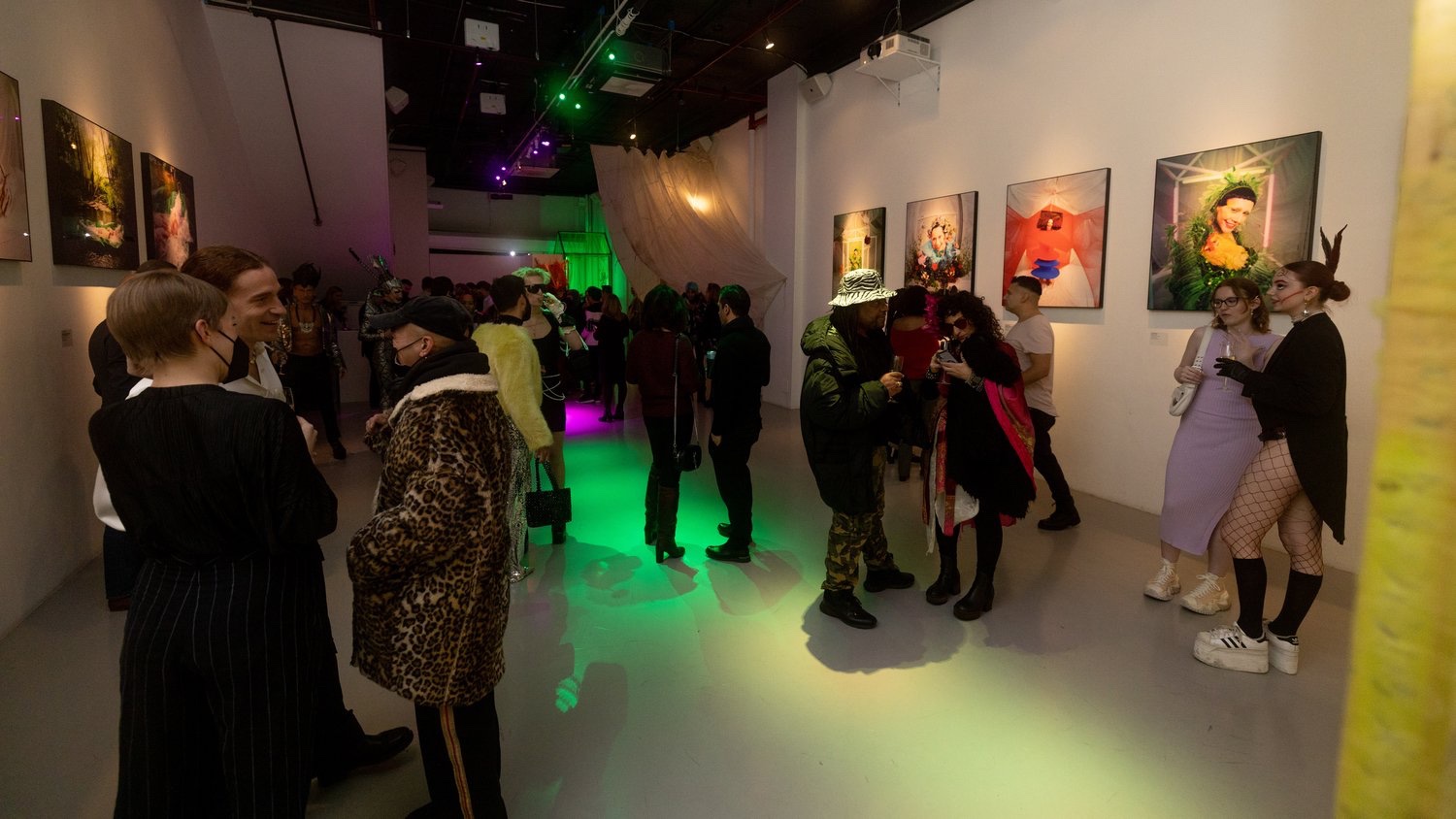 Leopard print coats and green uplighting animate the crowded Jordan Milligan gallery opening