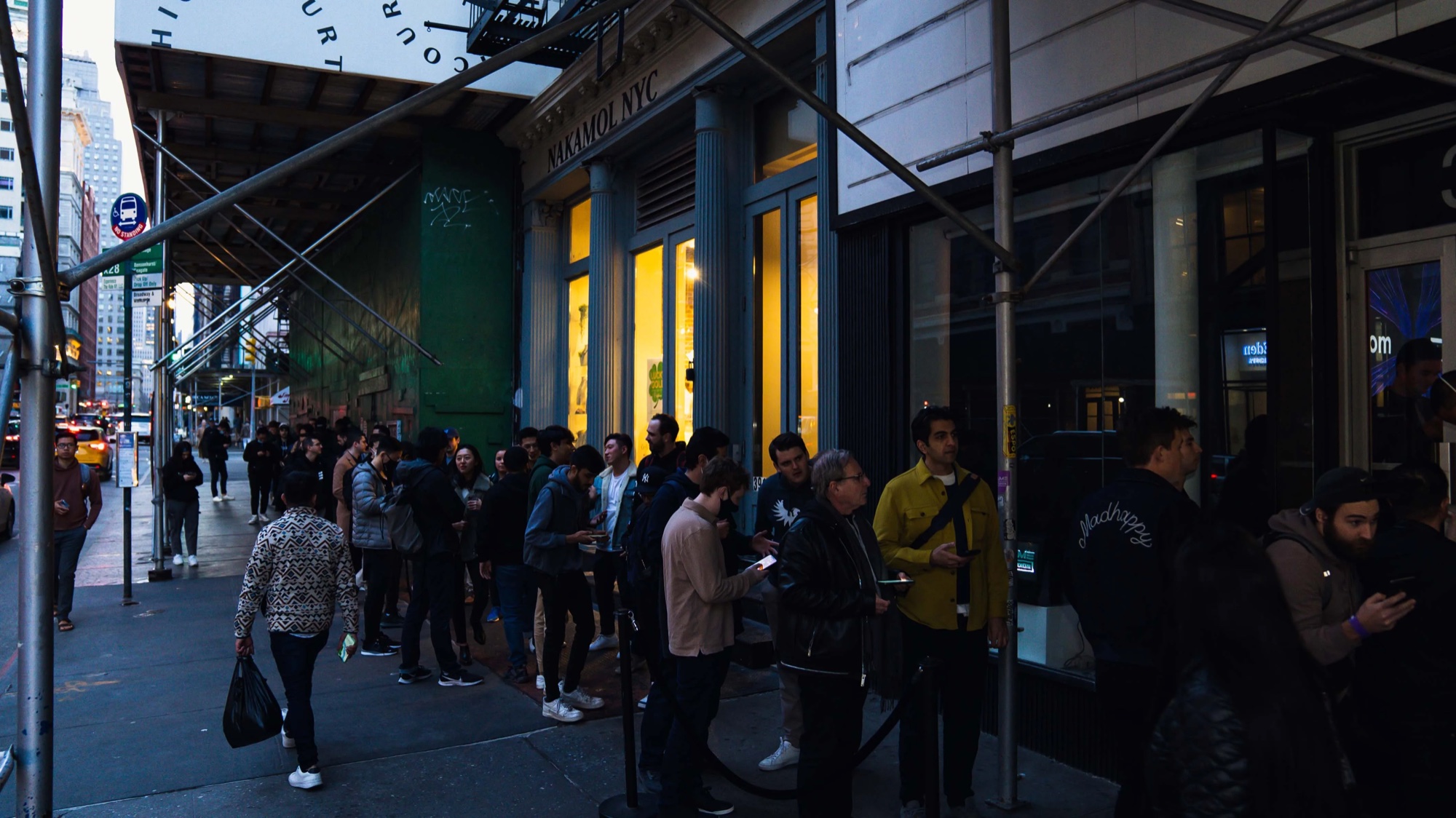 Line of guests waits outside the venue on a Tribeca street at dusk for Metaplex