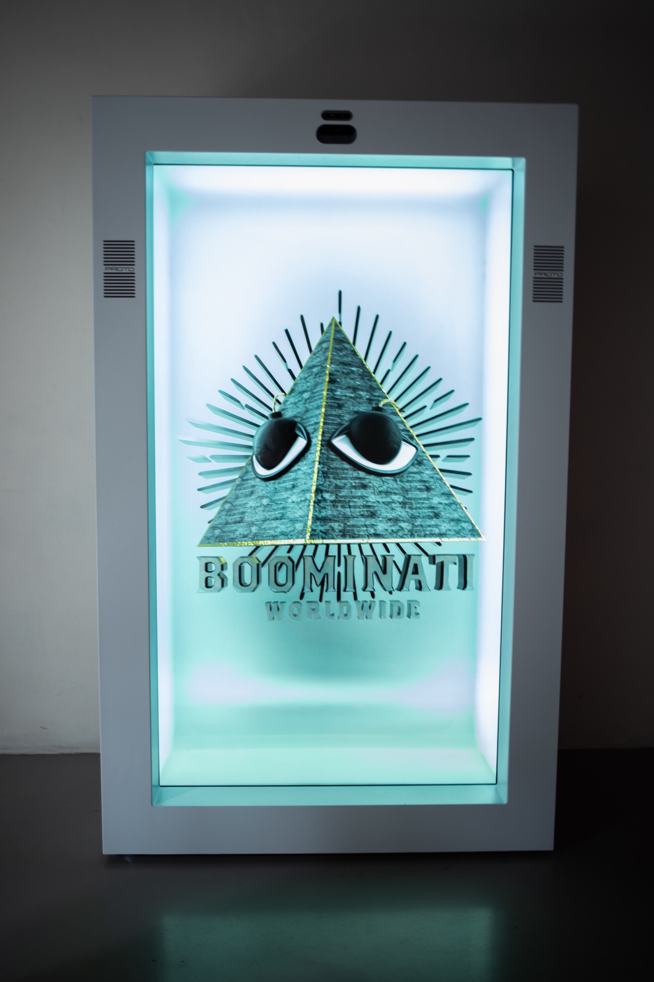 A glowing display case holds a pyramid with two eyes above the words Boominati Worldwide