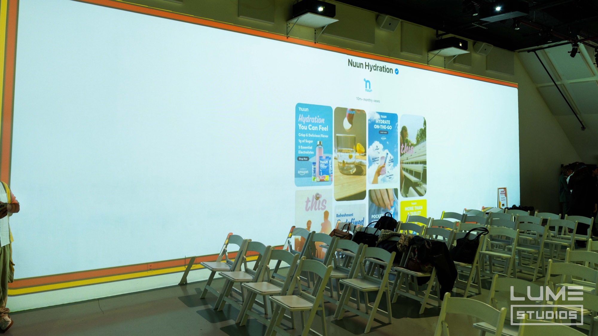 Nuun Hydration pins projected on a huge wall above rows of folding chairs