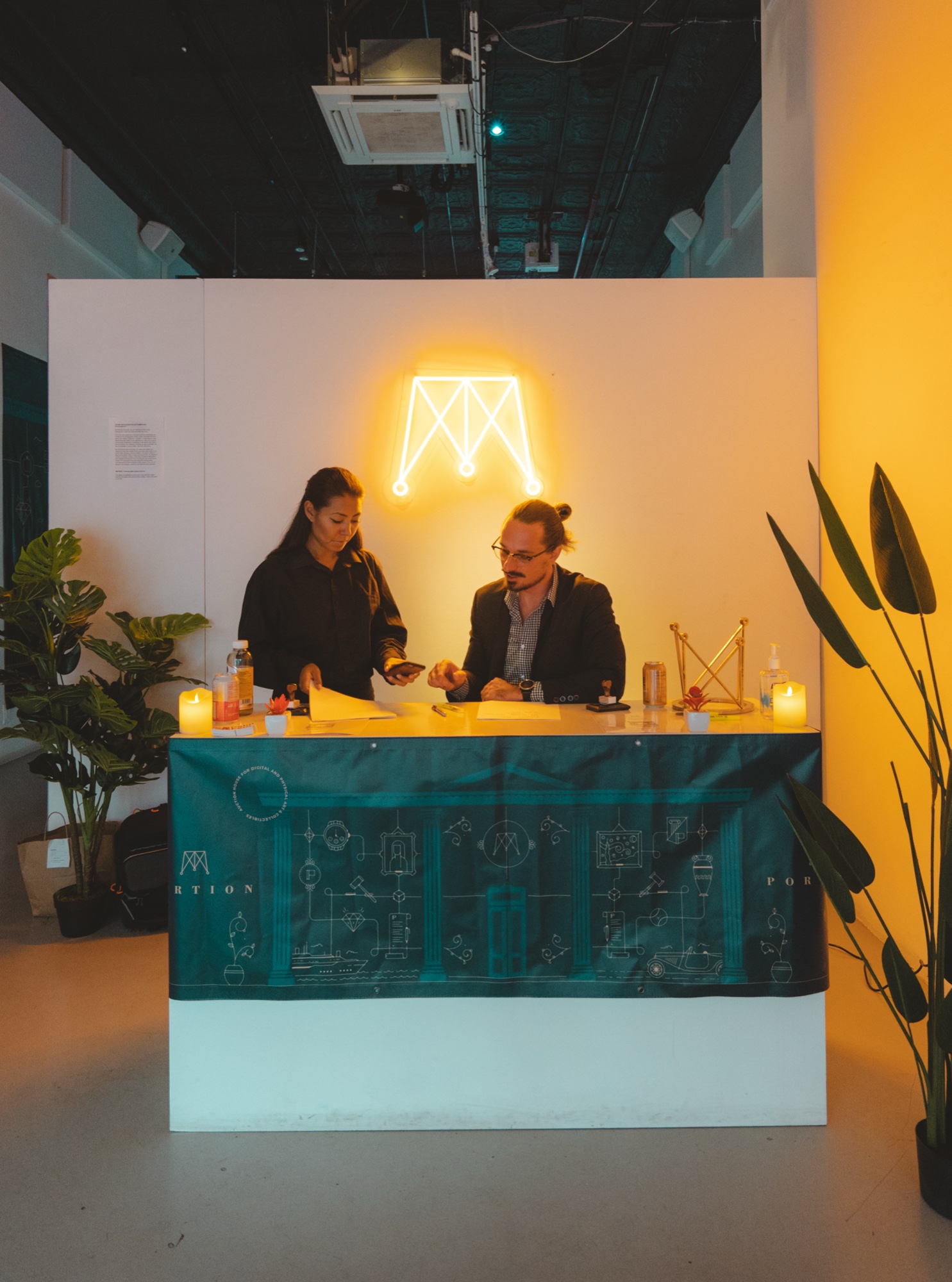 Five panelists seated beneath a yellow Portion logo projection at Lume Studios