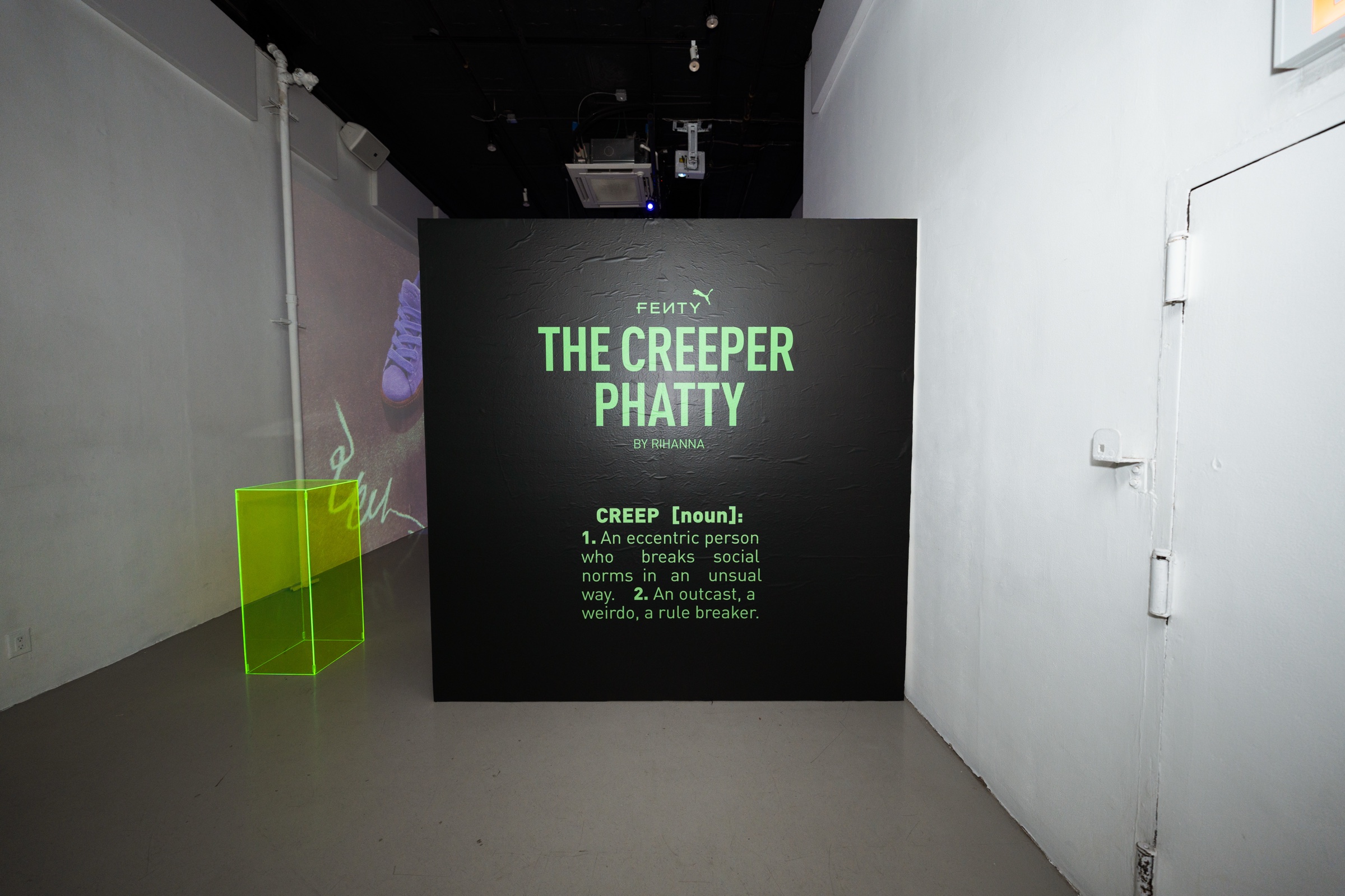 Giant Puma sneaker projections and a Fenty DJ booth fill an immersive room lit in blue