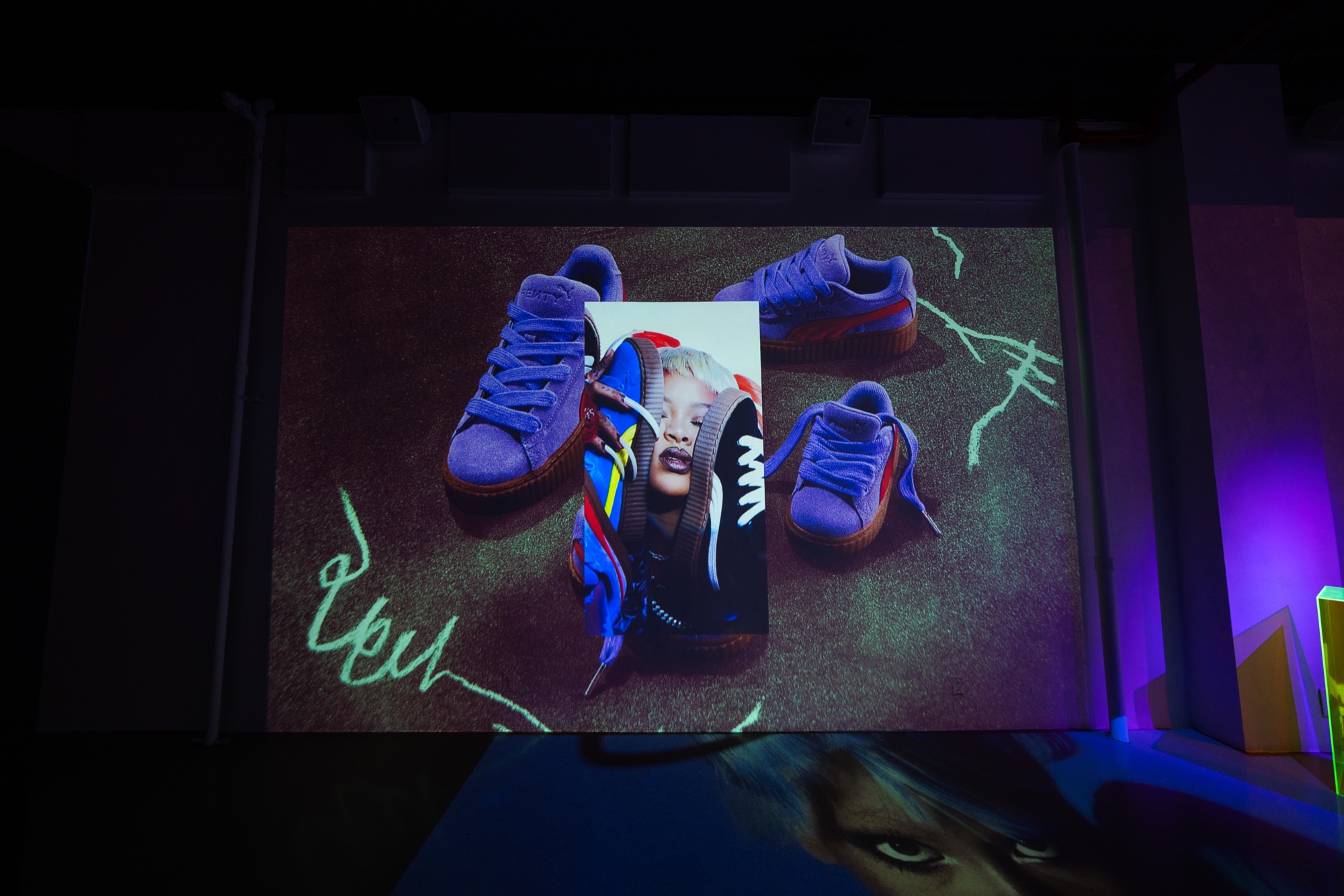 Fenty box and Creeper sneakers projected large across the wall at Puma x Fenty