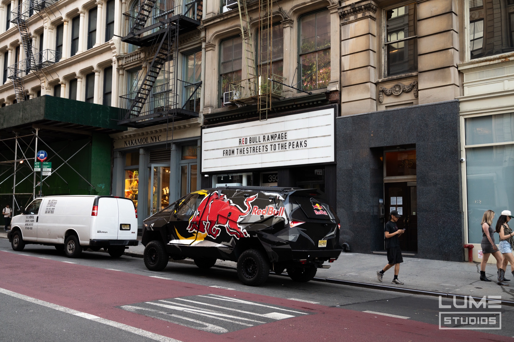 Red Bull wrapped pickup truck parked beneath a marquee reading Red Bull Rampage From The Streets To The Peaks