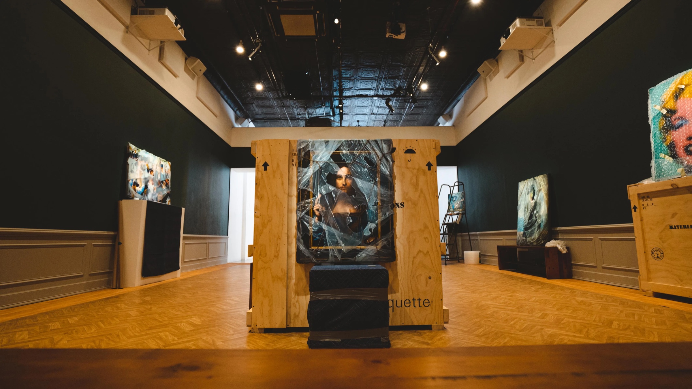 Plywood crate installation with a plastic wrapped Mona Lisa in the Robin Eley gallery
