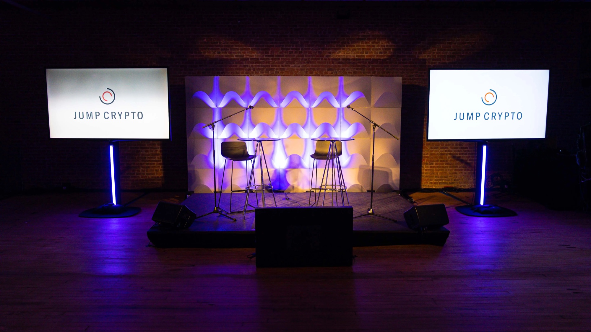 Stage with two Jump Crypto screens and stools ready for a Solana panel