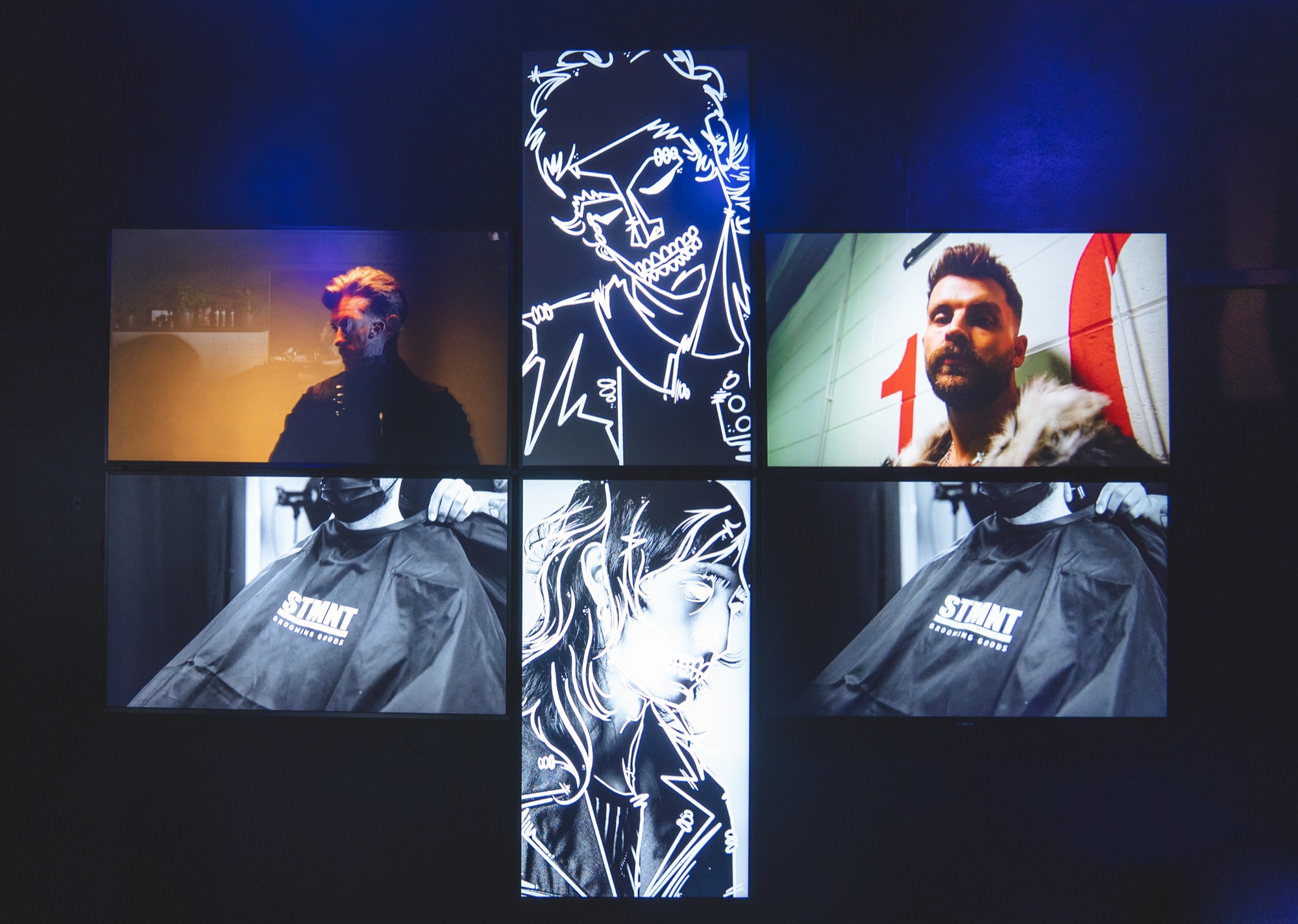 Grid of screens in a cross arrangement showing barbers at work and illustrated faces, lit in blue