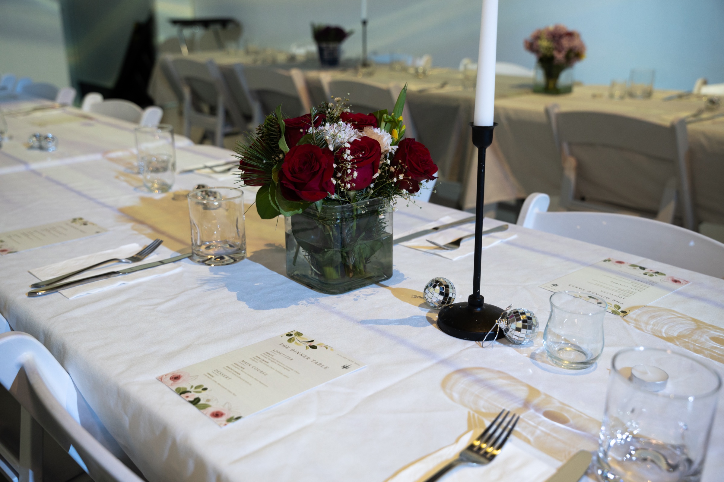 Cellist performs before towering flame projections at The Dinner Table candlelit dinner