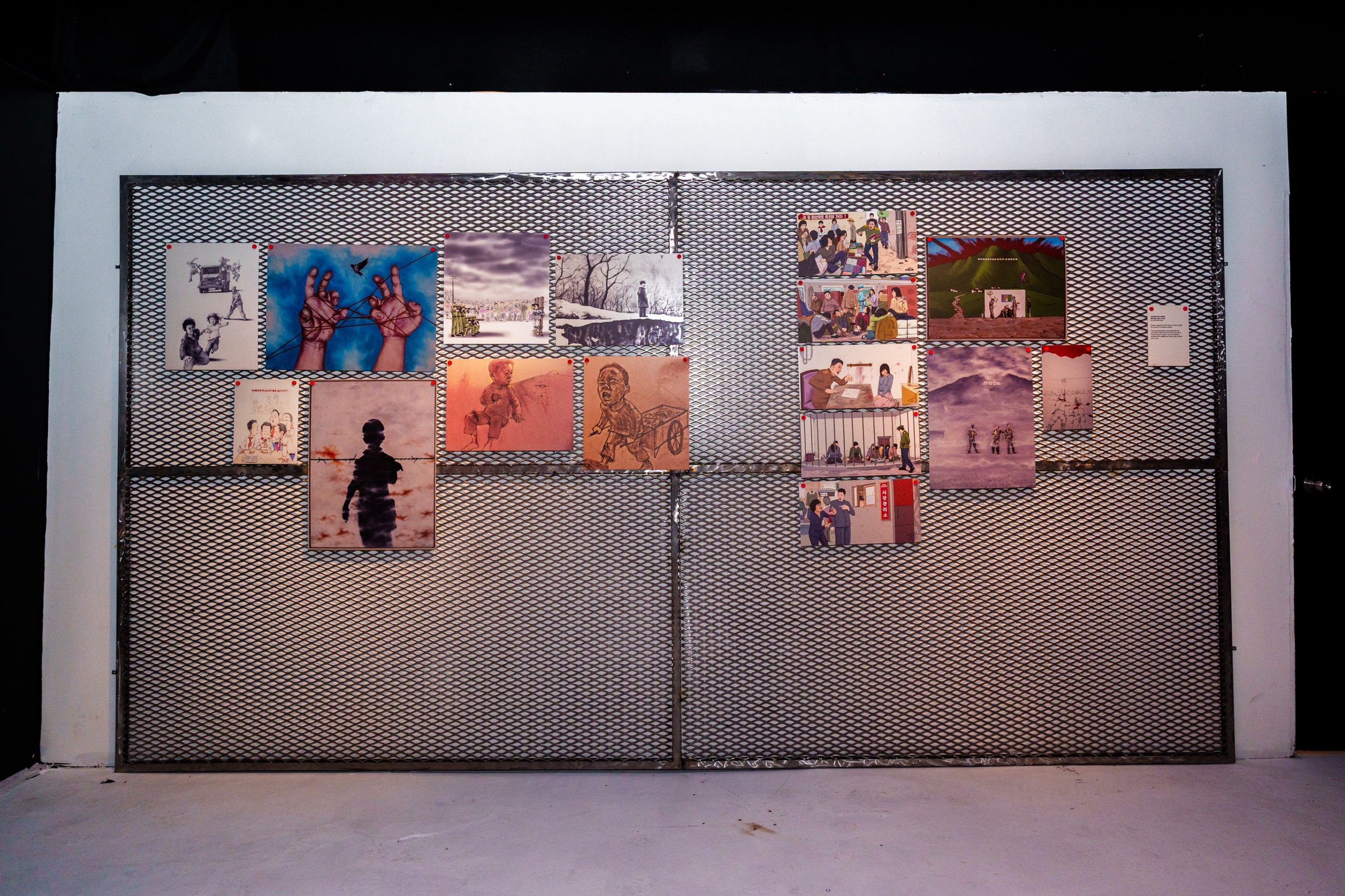 Marquee above the UNSEEN Exhibition storefront announcing fourteen artists on women's rights in North Korea