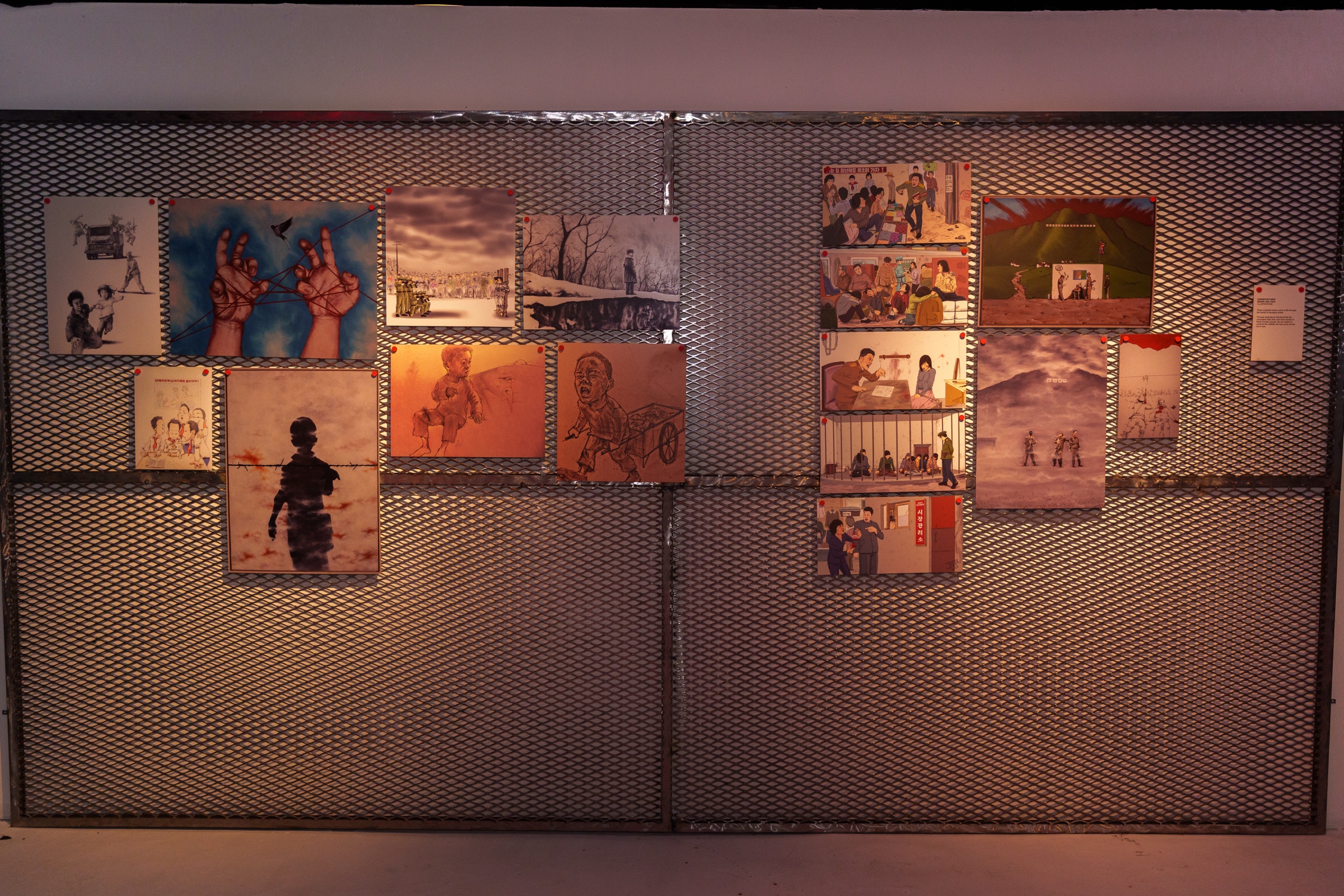 Silhouetted visitors before glowing red statistic panels inside the UNSEEN Exhibition