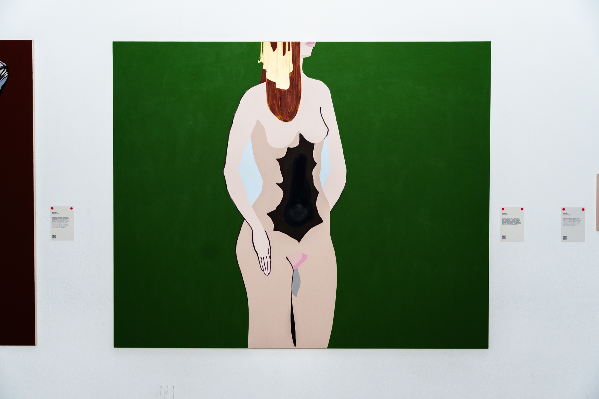 Large painting of a nude figure with red hair and a black shape at the torso on a green background