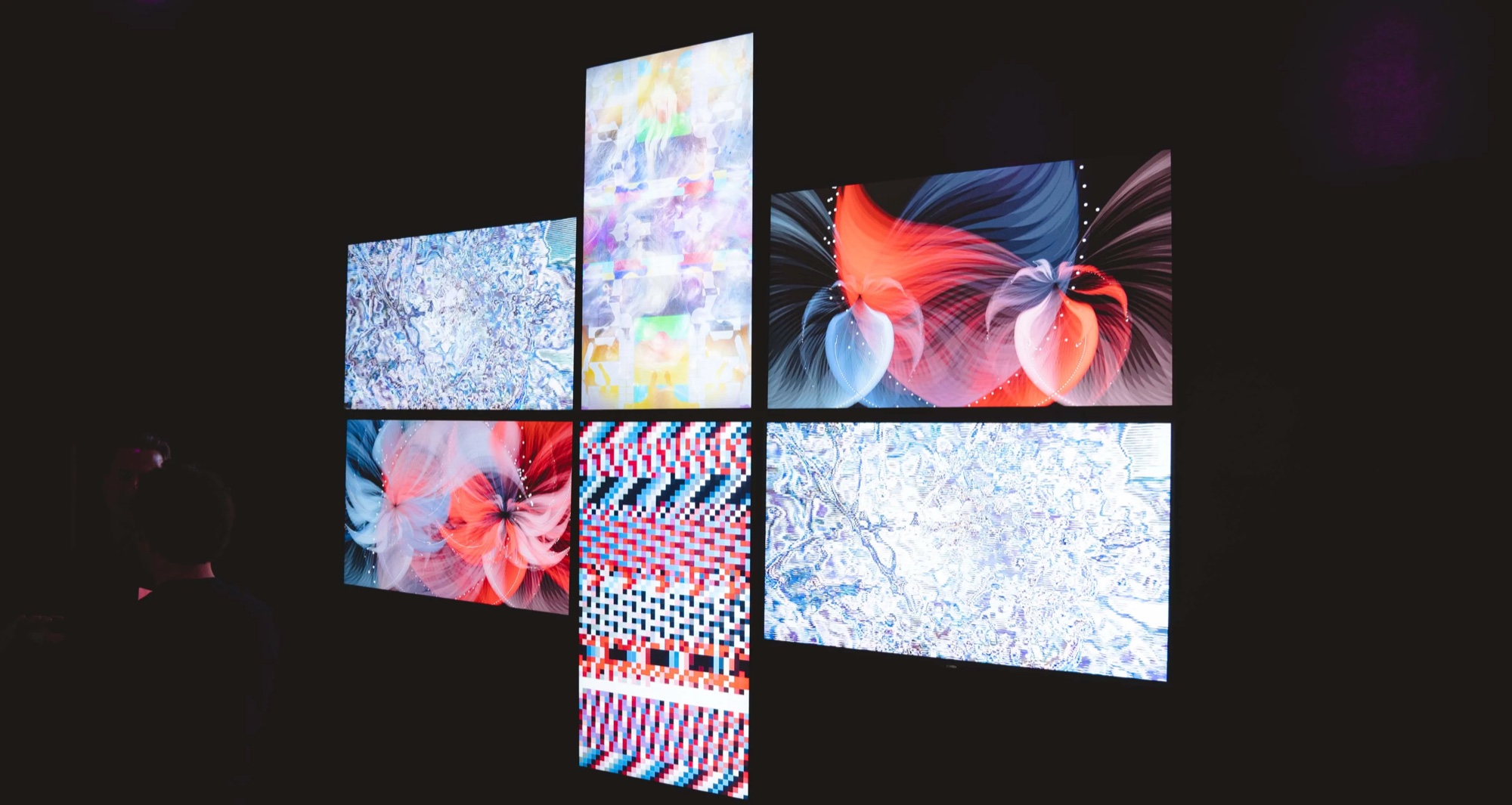 Cross shaped screen array showing floral digital artworks at Vertical Crypto Art