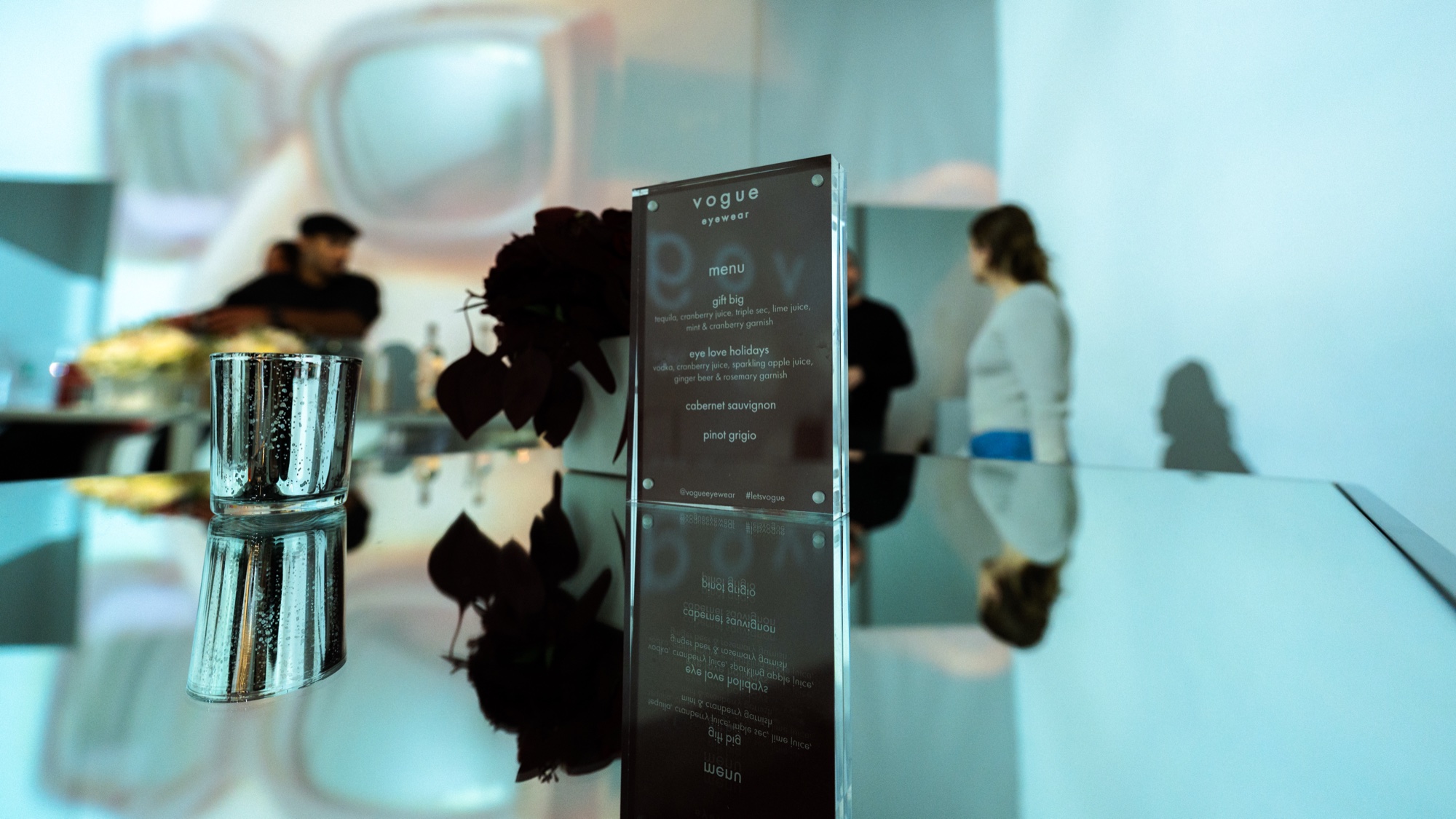 Vogue Eyewear logo projected in white bokeh on an empty wall before guests arrive