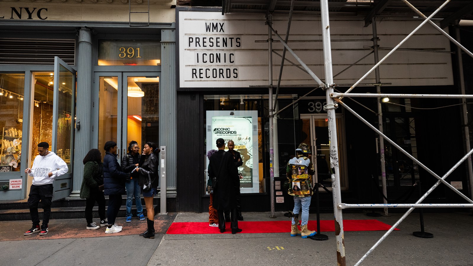 Marquee reading WMX Presents Iconic Records above a red carpet entrance with guests waiting on the sidewalk