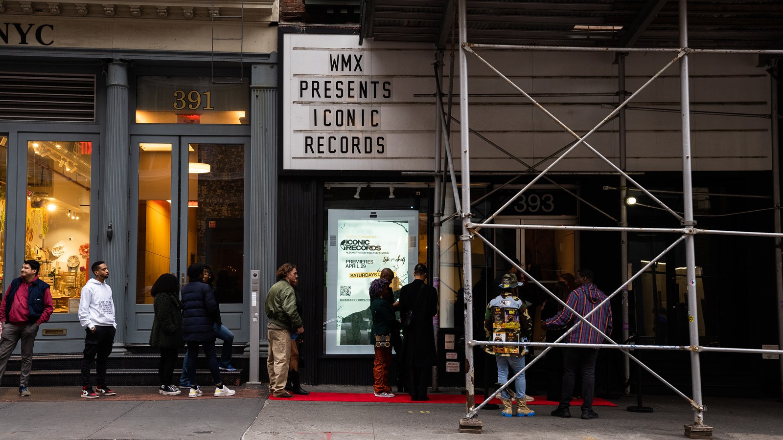 Line of guests outside a storefront at 391 with a WMX Presents marquee and a red carpet entrance