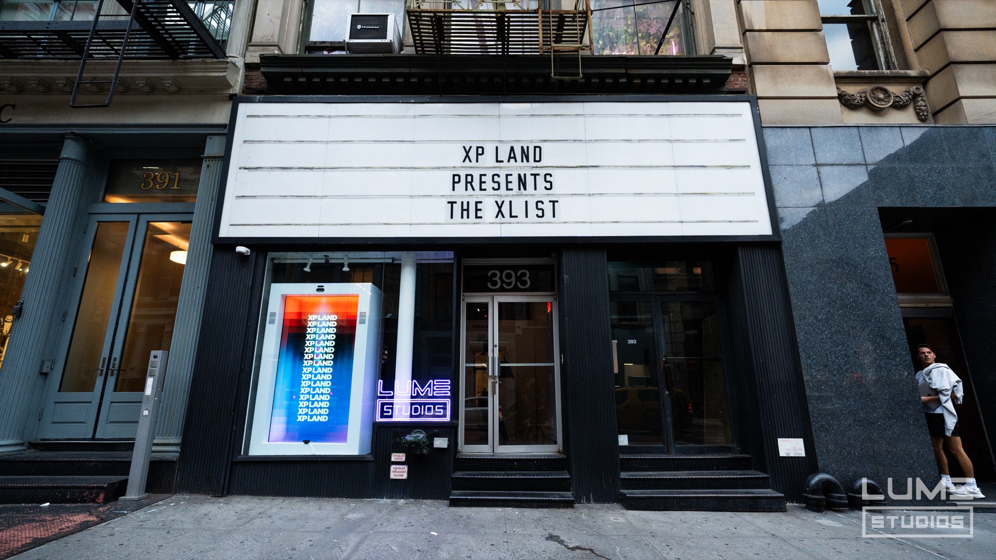 XP Land step and repeat wall beside a projection reading the fire behind the fandom